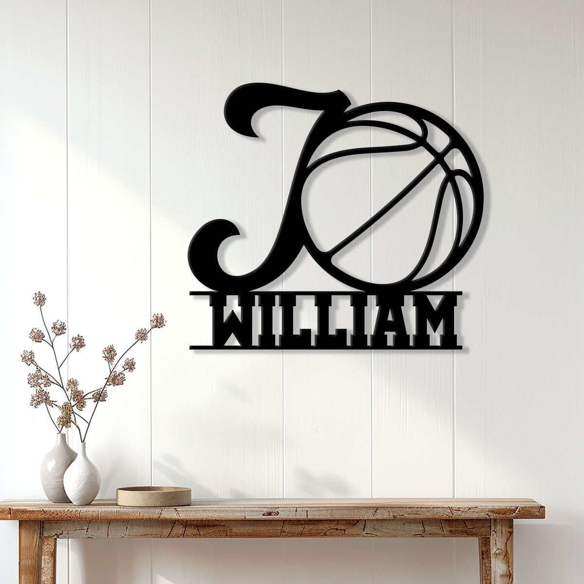 Black basketball metal wall sign displayed above a console table in a bright modern home