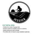 Surfing metal sign feature graphic showing a circular female surfer and wave design
