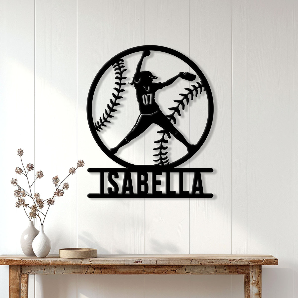 Softball wall sign displayed on a white paneled wall above a console table