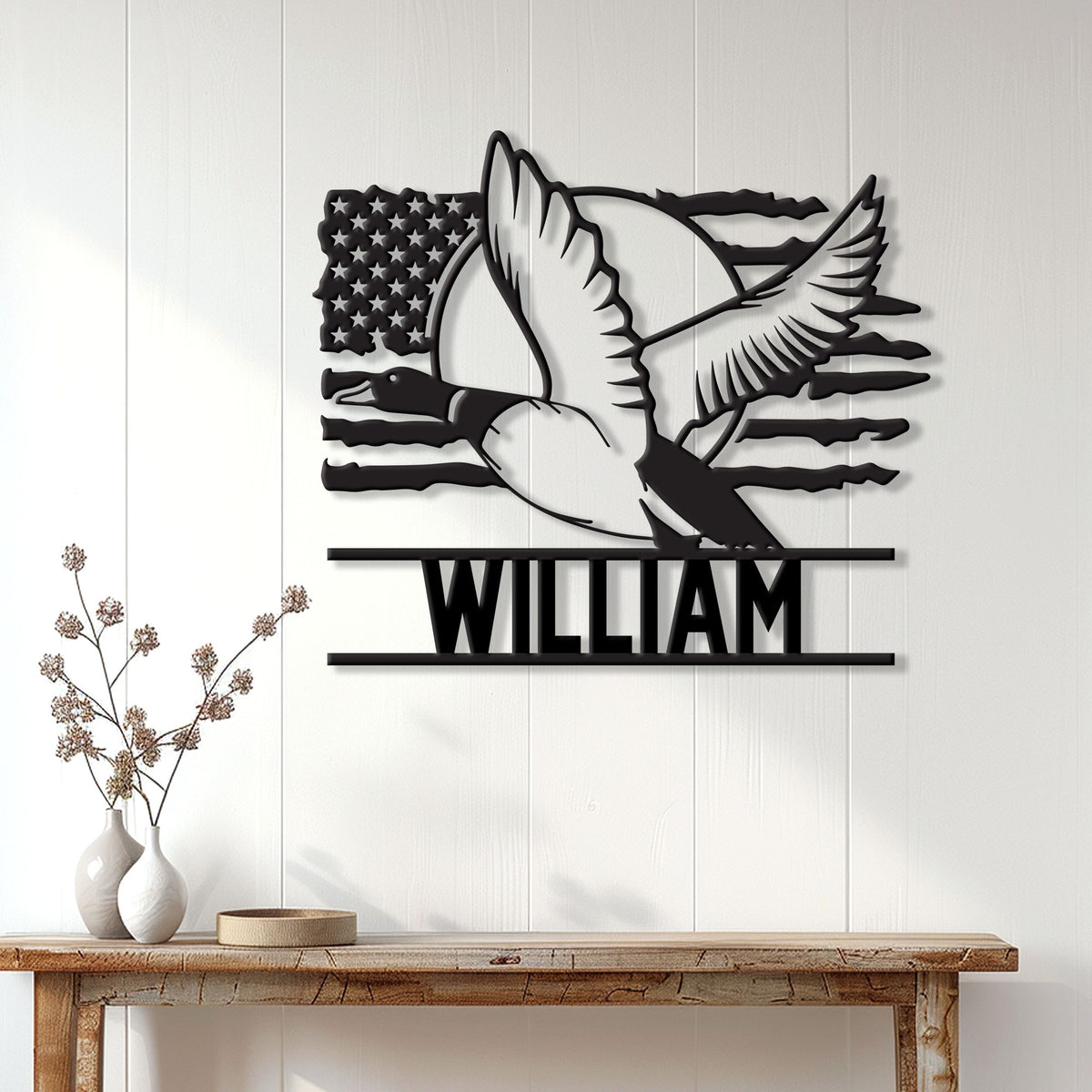 Flying duck hunting wall sign displayed on a light wood-paneled wall above a console table
