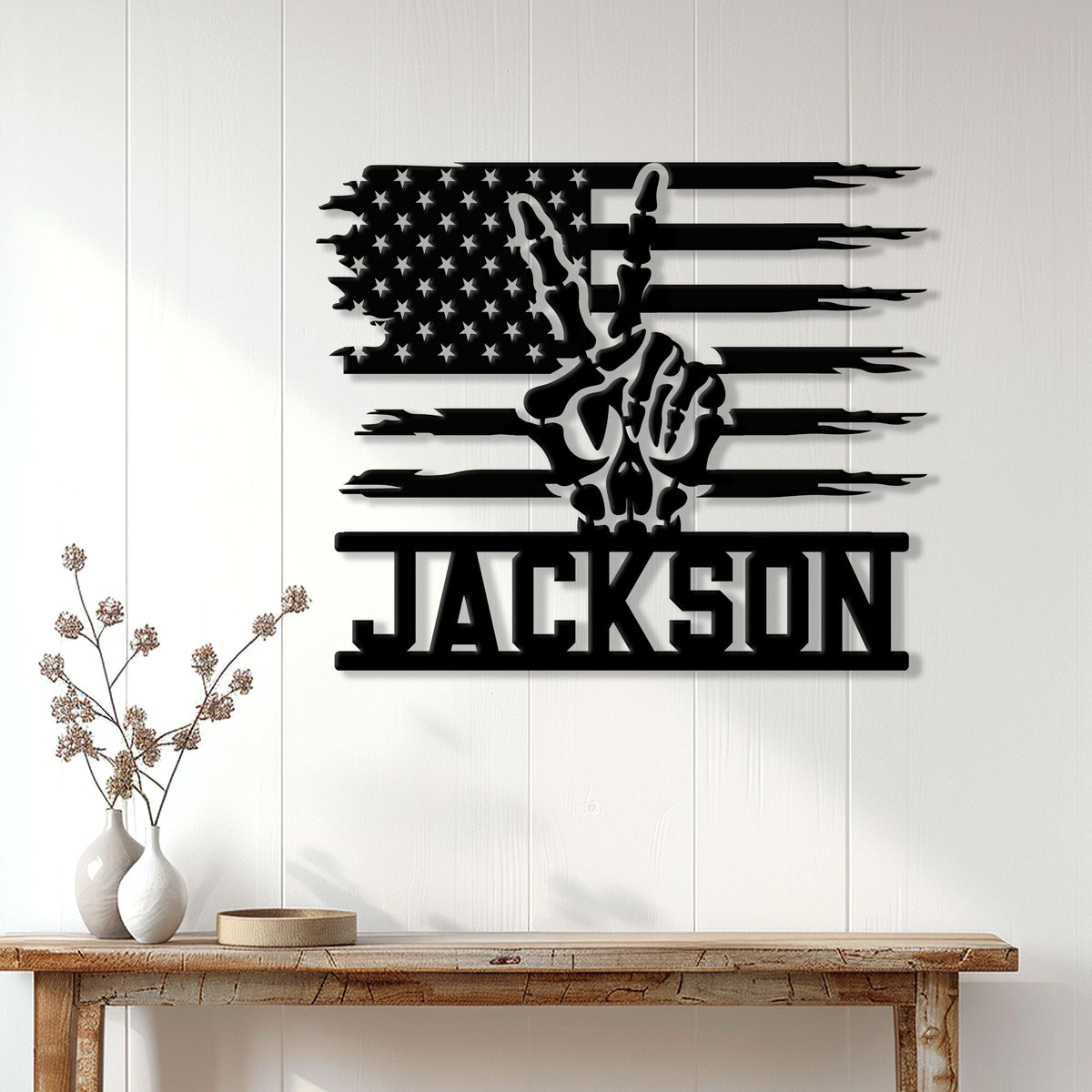 Black skull and American flag metal sign displayed on a white paneled wall