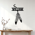 Native American feather dreamcatcher metal sign displayed on a light wood-paneled wall above a console table