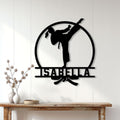Karate martial artist metal sign displayed on a light wood-paneled wall above a console table