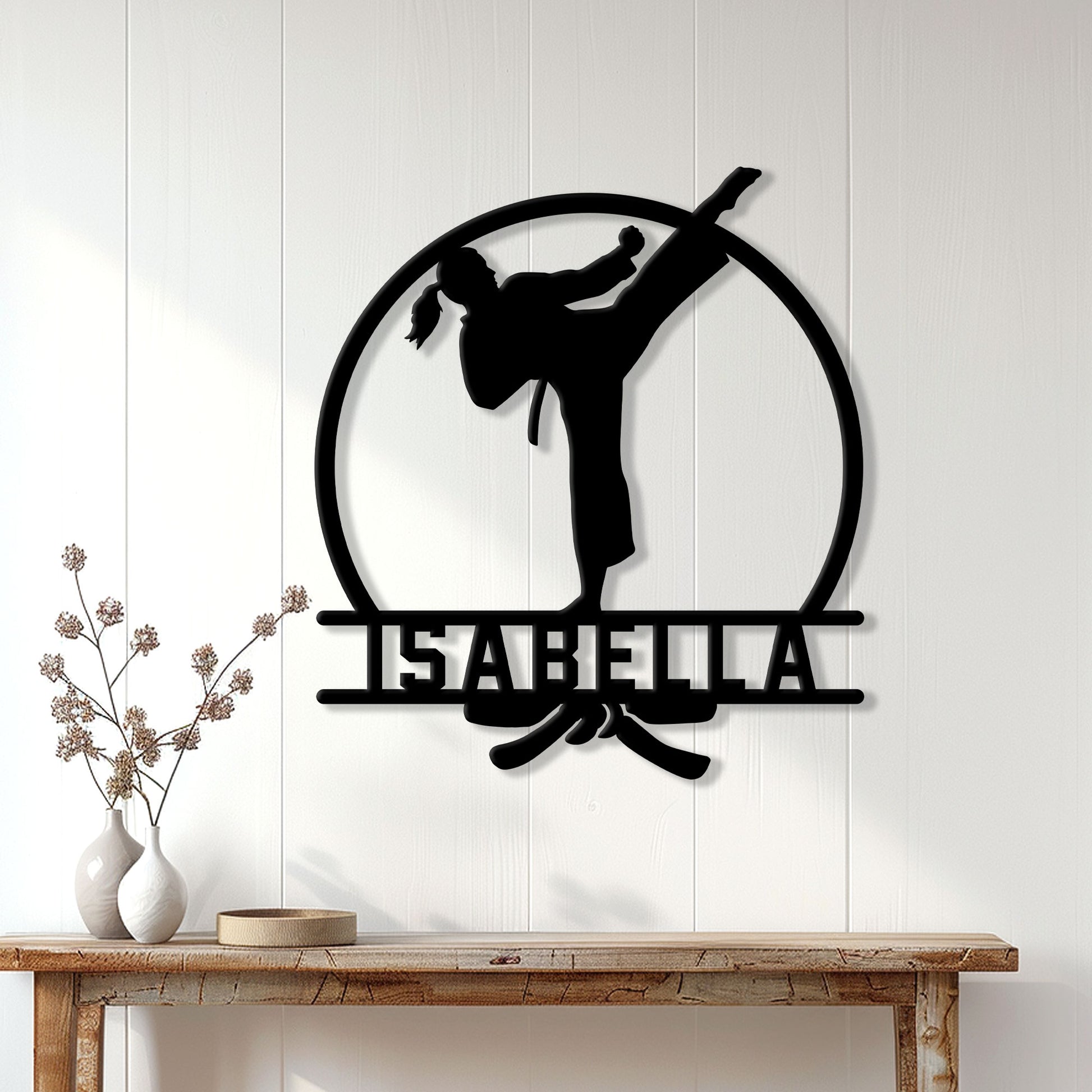 Karate martial artist metal sign displayed on a light wood-paneled wall above a console table