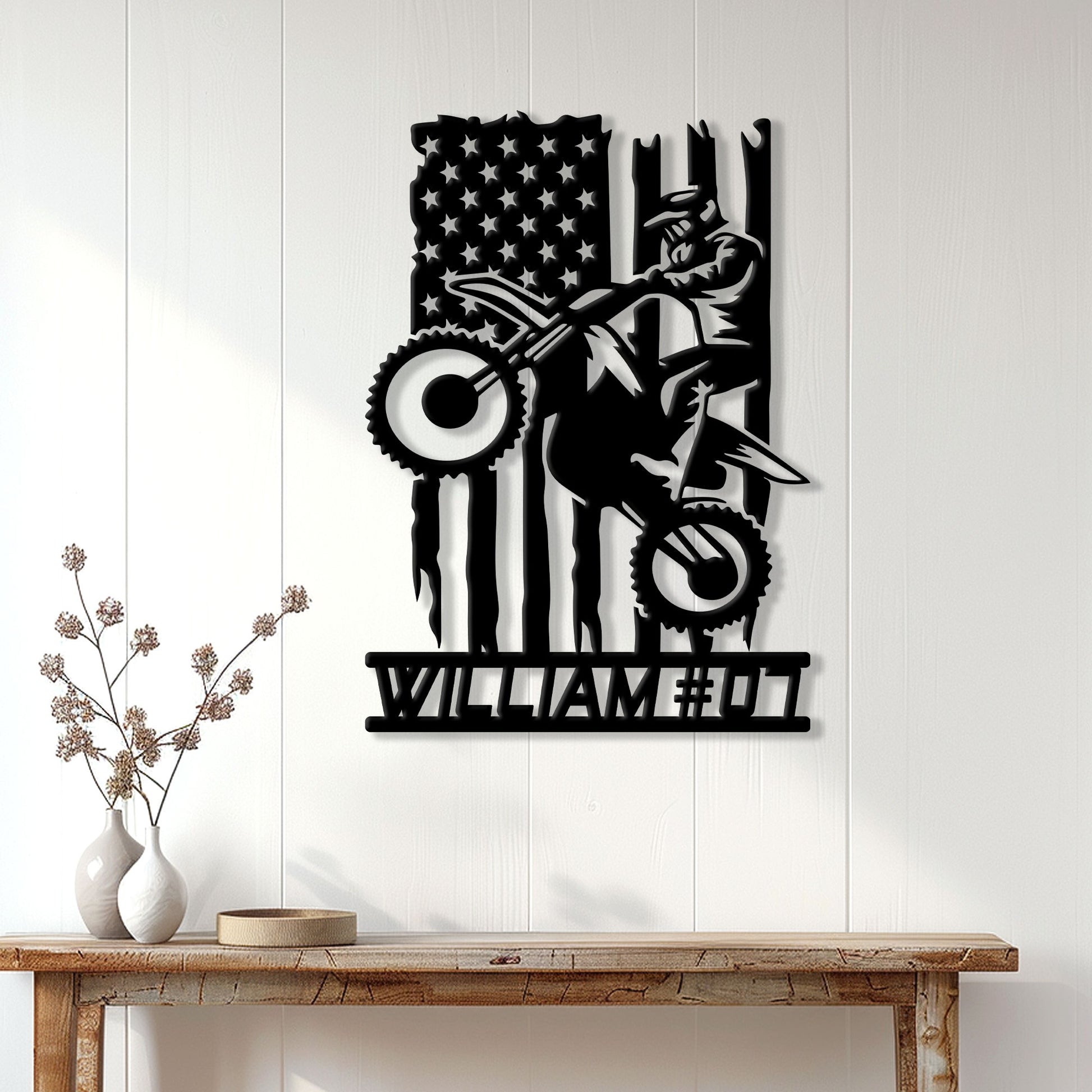 Motocross metal wall sign displayed on a bright paneled wall above a rustic console table