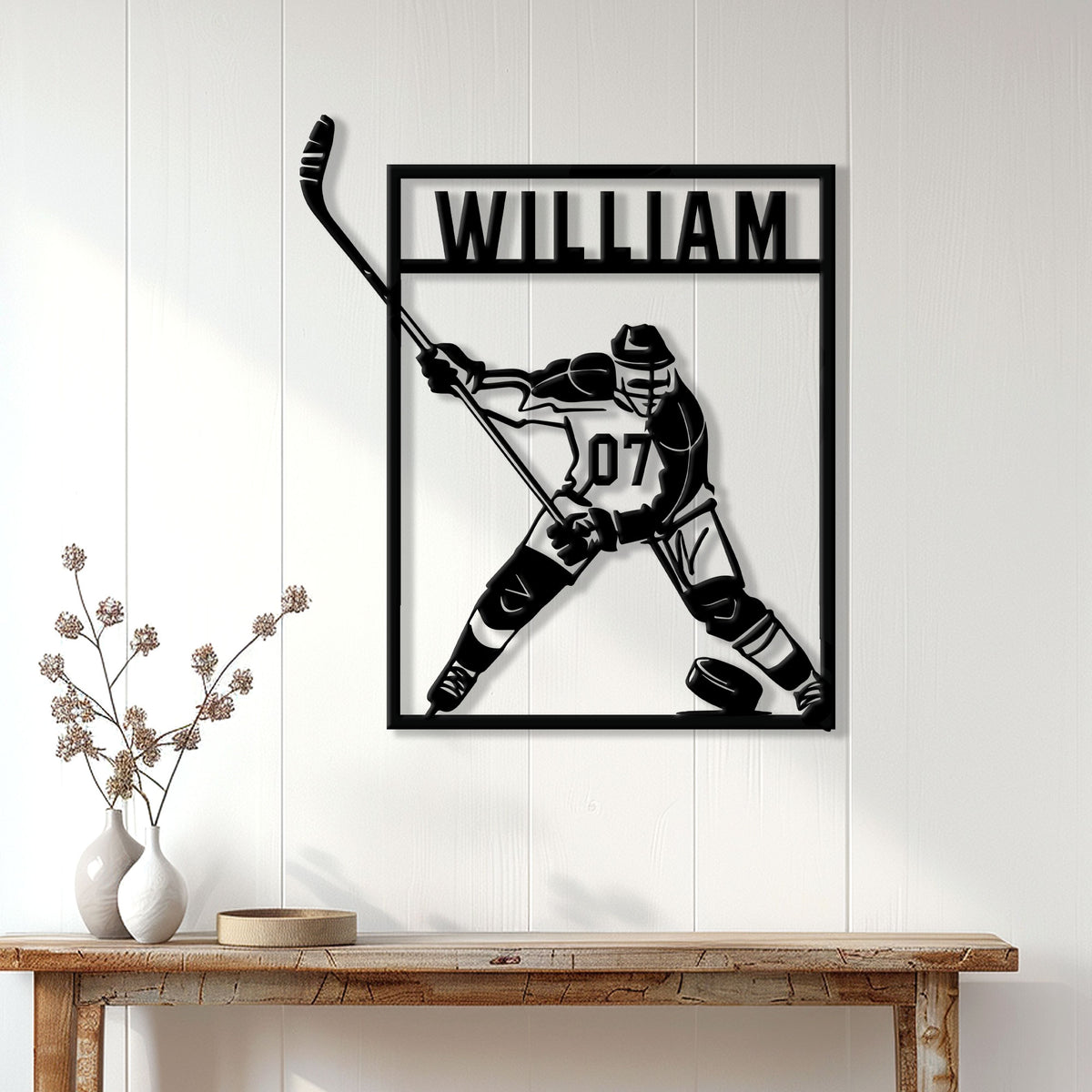 Hockey player metal wall sign displayed on a white paneled wall above a wood console table