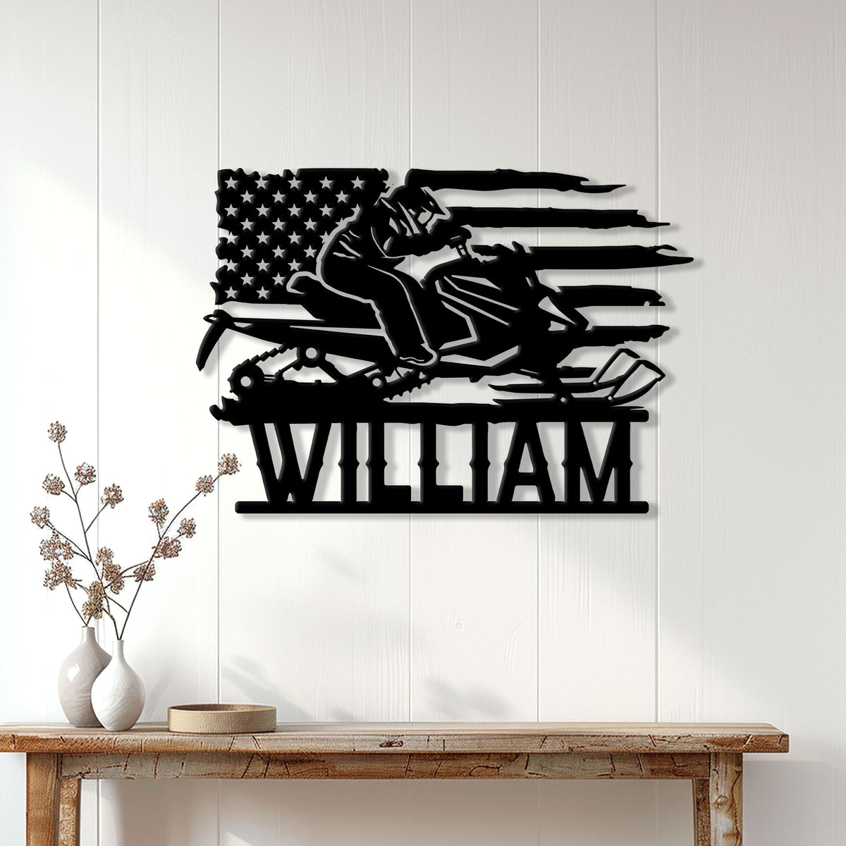 Patriotic snowmobile wall sign displayed above a console table in a bright home interior