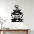 Pirate skull and anchor metal wall sign displayed on a white paneled wall above a console table