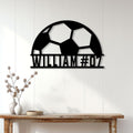 Soccer ball metal wall sign styled above a console table in a bright home interior