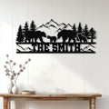 Black bear family silhouette wall sign displayed above a console table in a rustic home