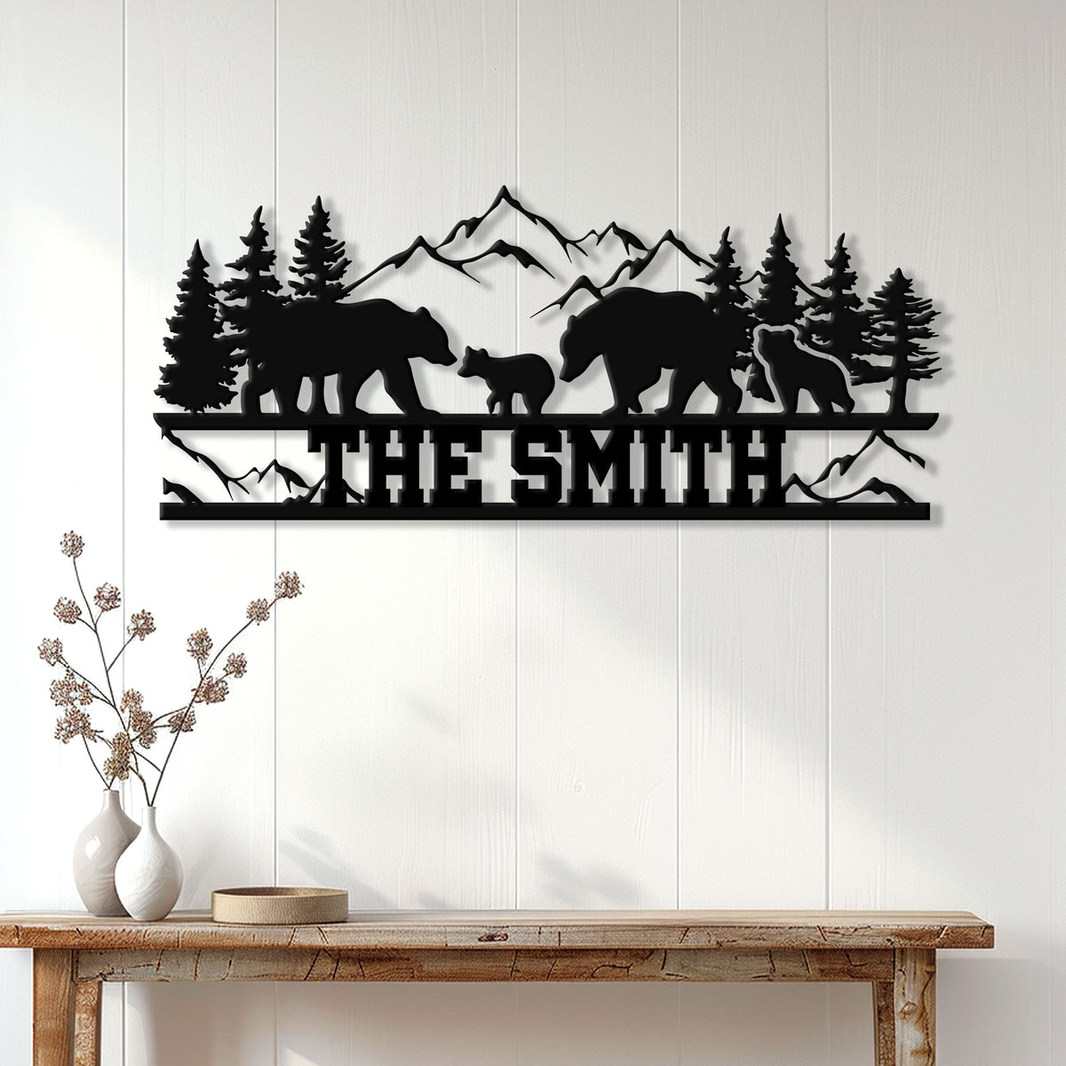 Black bear family silhouette wall sign displayed above a console table in a rustic home