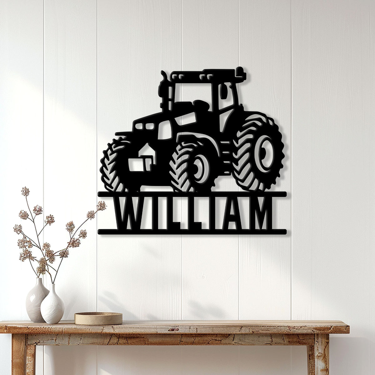 Black tractor wall sign displayed on a light paneled wall above a rustic console table