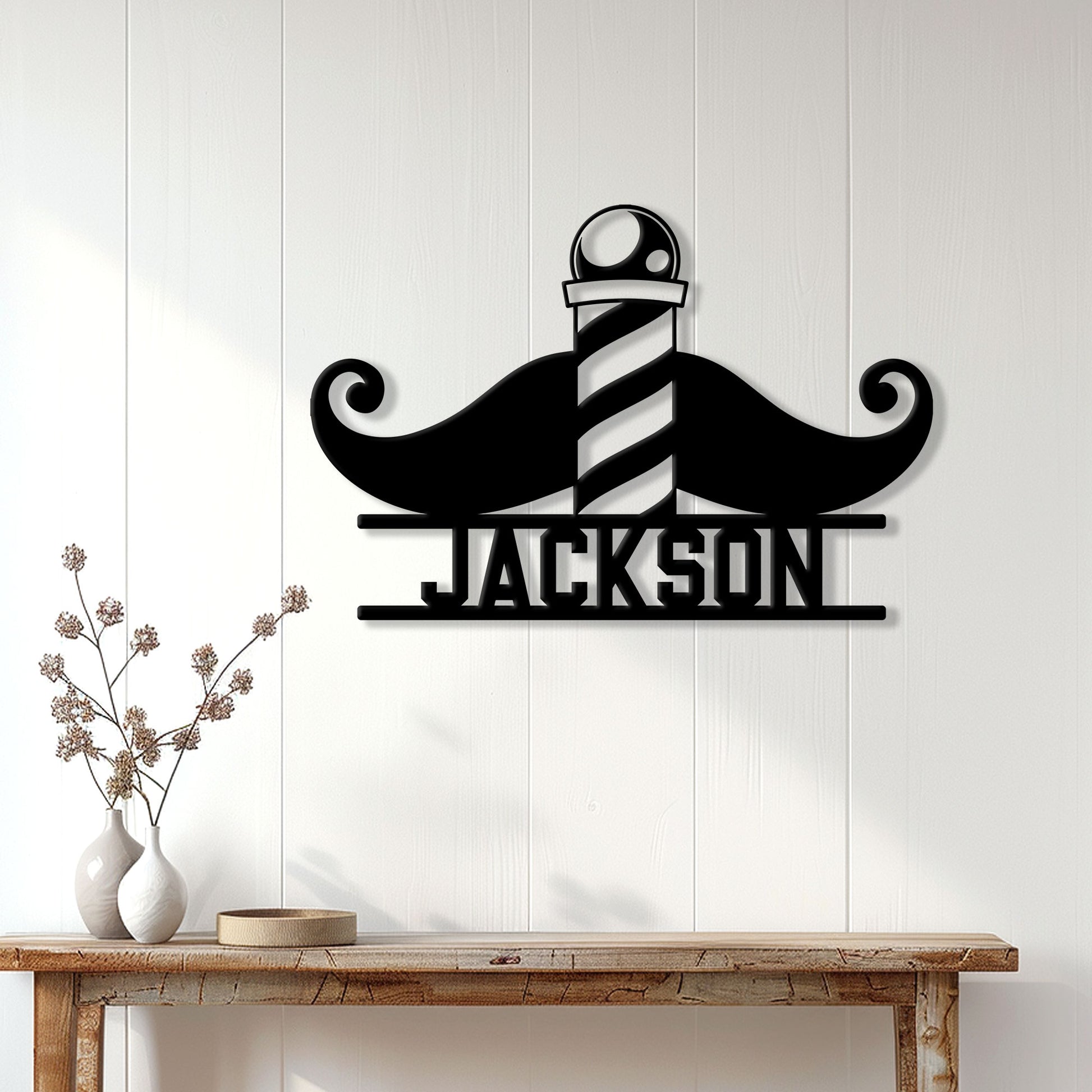 Black mustache and barber pole wall sign displayed on a light wood-paneled entryway