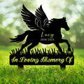 Winged horse silhouette memorial metal sign displayed in a green garden setting