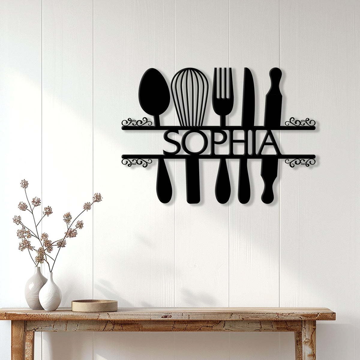 Black kitchen utensil metal sign mounted on a bright farmhouse-style wall