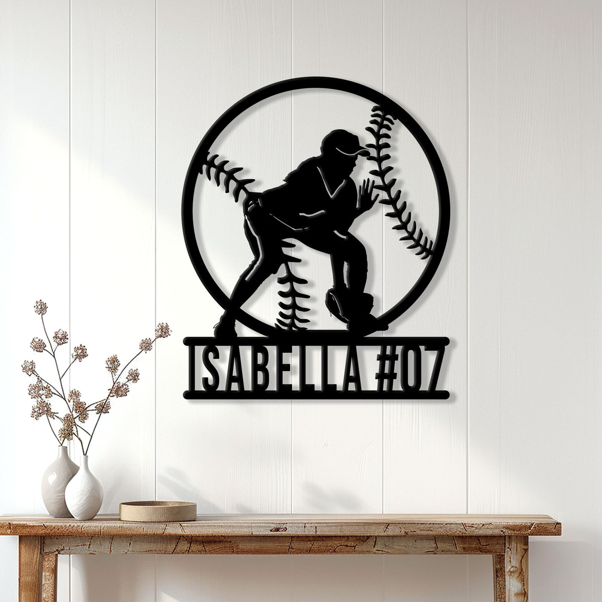 Softball metal wall sign displayed on a white paneled wall above a wooden console table