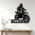 Motocross rider metal wall sign displayed on a light wood-paneled interior wall