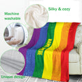 LGBT Pride rainbow blanket draped over a sofa with cozy texture and feature callouts