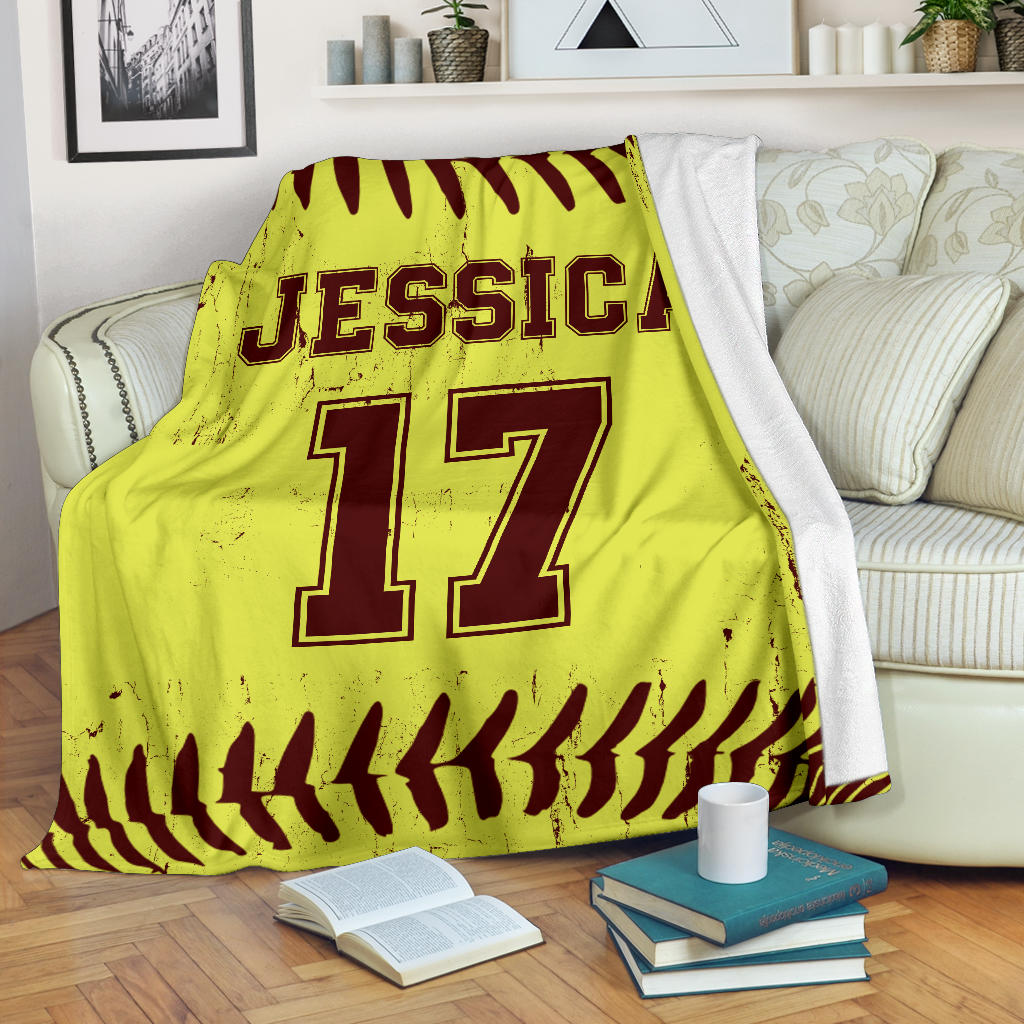 Yellow and burgundy softball blanket draped over a sofa with athletic jersey-style design