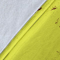 Close-up of the yellow softball blanket fabric, stitched edge, and burgundy distressed sports artwork