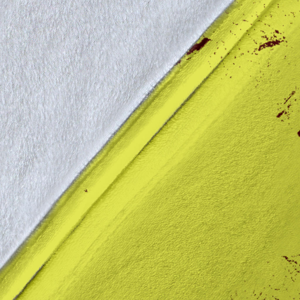 Close-up of the yellow softball blanket fabric, stitched edge, and burgundy distressed sports artwork