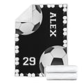 Soccer blanket product display featuring black and white ball artwork and folded blanket detail