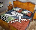 American football quilt styled across a bedroom bed with player artwork and oversized football graphics