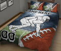 Football quilt blanket shown on a bed with a crouching player, field background, and large football design