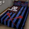 Angled bedroom view of a black and blue lacrosse quilt blanket with crossed stick artwork
