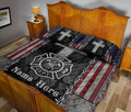 Firefighter quilt blanket styled on a bedroom bed with fire department emblem, crosses, and American flag pattern