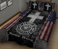 Patriotic firefighter quilt blanket on a bed featuring a large silver cross and fire department emblem
