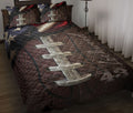 Football quilt bedding set styled on a bed with rugged brown leather textures, stars, and patriotic red, white, and blue accents