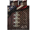 Full view of a football quilt bedding set featuring a large laced football, textured brown background, and star accents