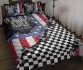 Racing quilt blanket displayed on a bed with checkered flags, red white blue graphics, and bold motorsport artwork