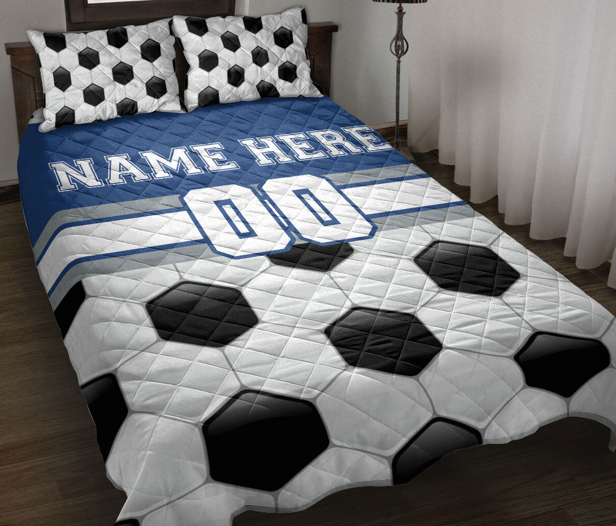 Soccer quilt blanket displayed on a bed with black and white ball artwork and blue jersey-inspired accents