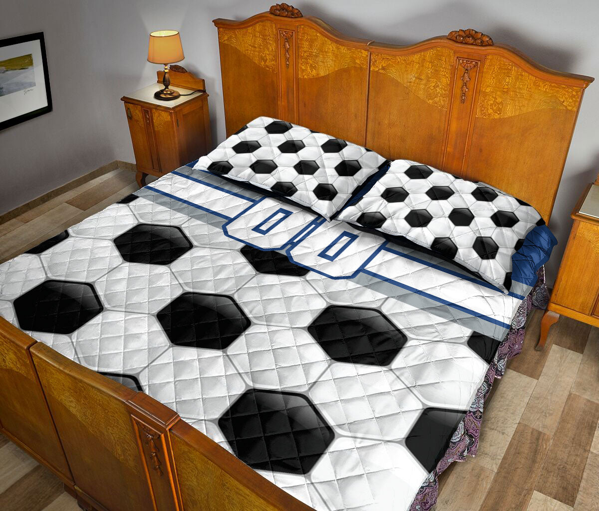 Soccer-themed quilt blanket styled across a bedroom with black and white ball artwork and blue accents