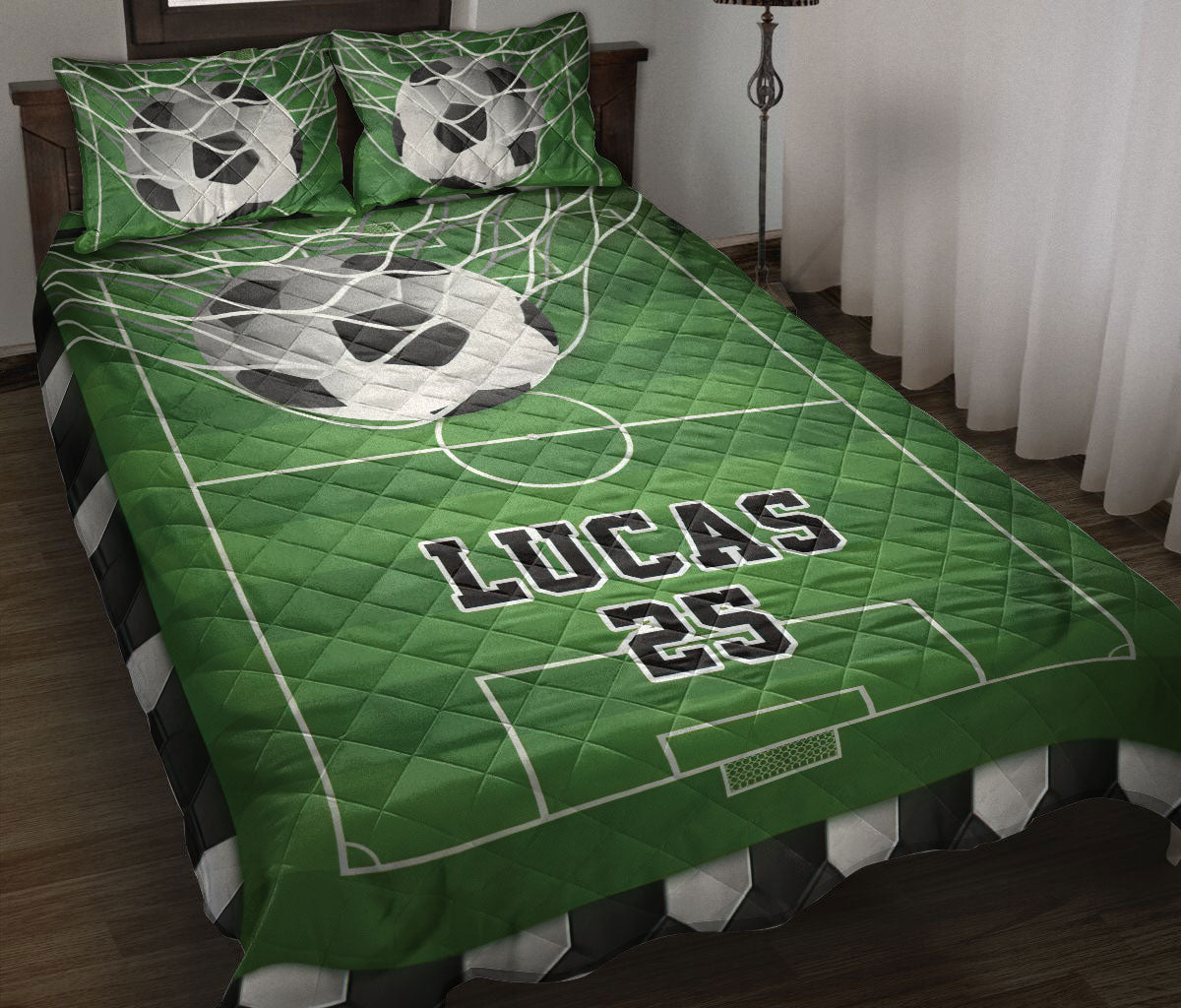 Green soccer quilt blanket displayed on a bed with soccer balls, field markings, and matching pillow artwork