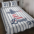Baseball quilt blanket styled on a bed with patriotic ballplayer artwork and striped sports design
