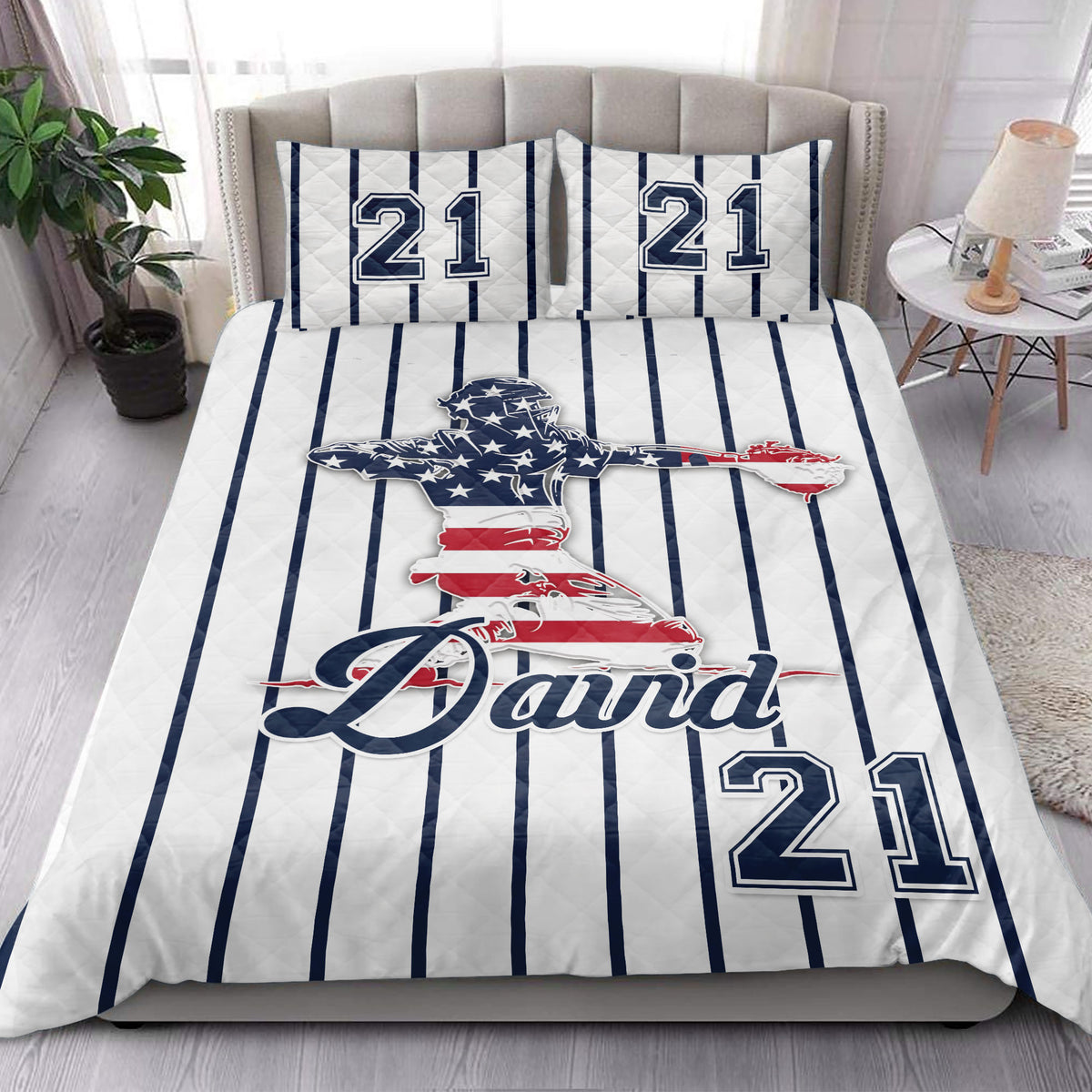 Baseball quilt blanket displayed in a bright bedroom with striped sports artwork and ballplayer design