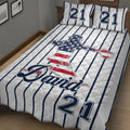 Baseball quilt bedding styled in a bedroom with patriotic ballplayer artwork and striped navy design