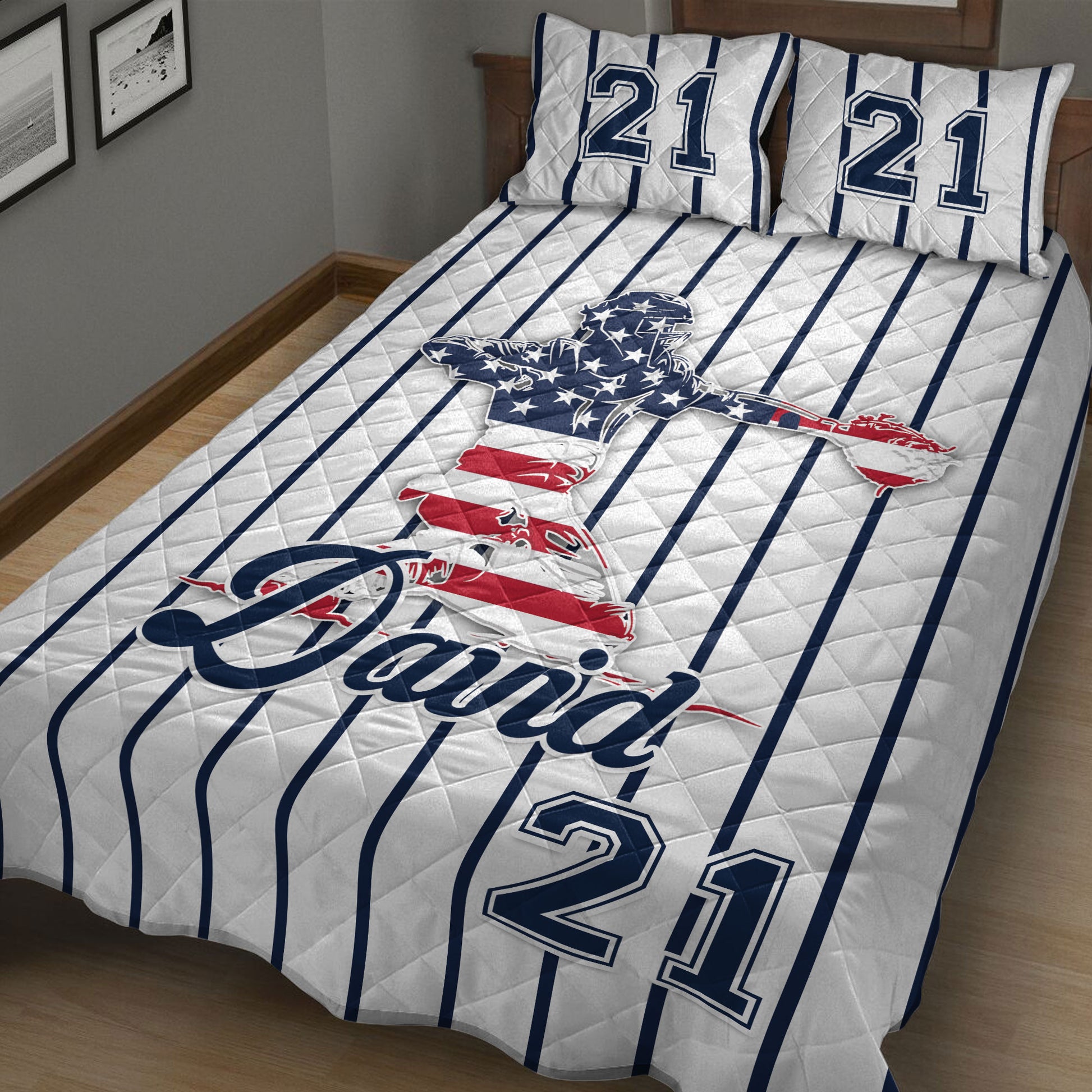 Baseball quilt bedding styled in a bedroom with patriotic ballplayer artwork and striped navy design
