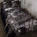 Black skull quilt blanket displayed on a bed with matching skull artwork and gothic bedroom styling