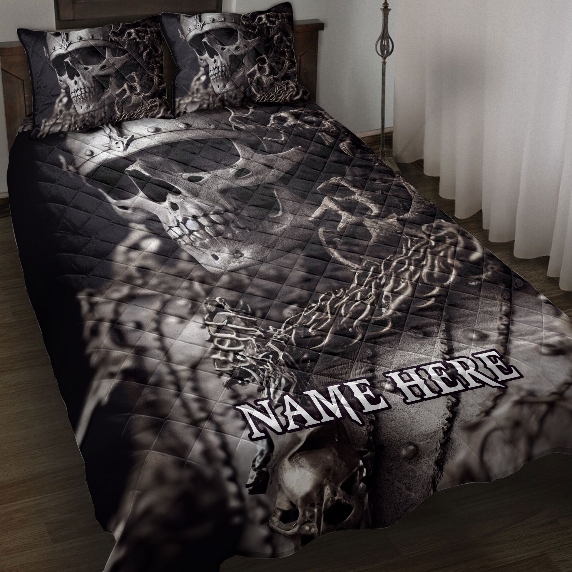 Black skull quilt blanket displayed on a bed with matching skull artwork and gothic bedroom styling