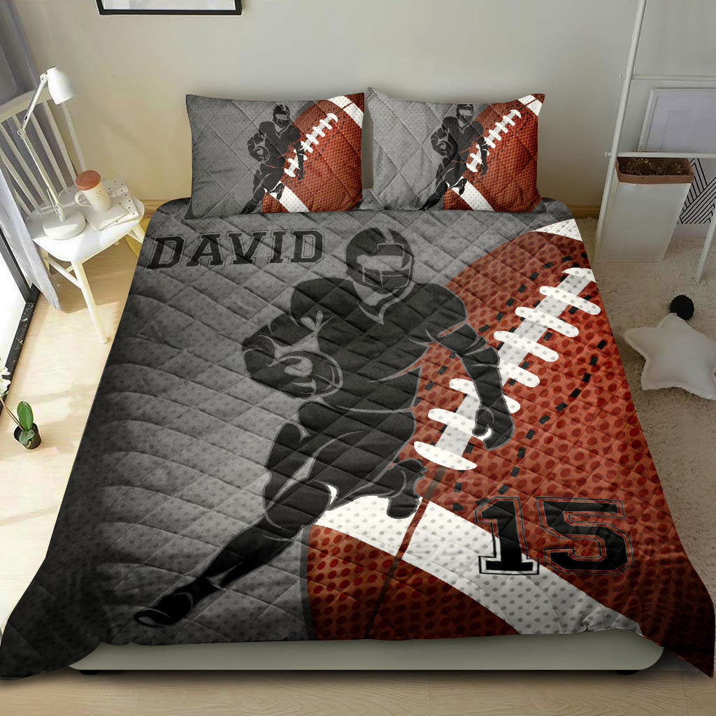 Football quilt bedding set styled in a bedroom with a running player silhouette, football pattern, and bold sports colors
