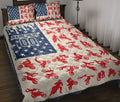 Motocross quilt blanket displayed on a bed with red dirt bike silhouettes, blue stars, and patriotic colors