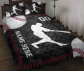 Baseball quilt blanket styled on a bed with batter silhouettes, baseballs, and black and red sports artwork