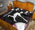 Baseball quilt blanket displayed on a bedroom bed with bold batter silhouettes and black and red baseball details