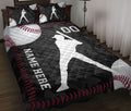 Baseball quilt blanket displayed on a bed with batter silhouettes, baseballs, and black and red sports artwork