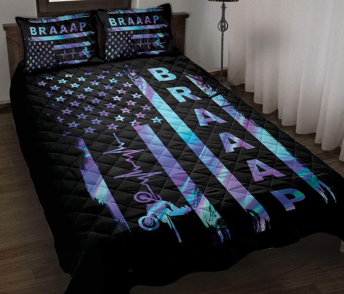 Motocross quilt blanket displayed on a bed with neon dirt bike graphics, stars, and bold black and blue artwork