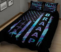 Black motocross quilt blanket on a bed featuring neon motorcycle silhouettes, stars, stripes, and racing artwork